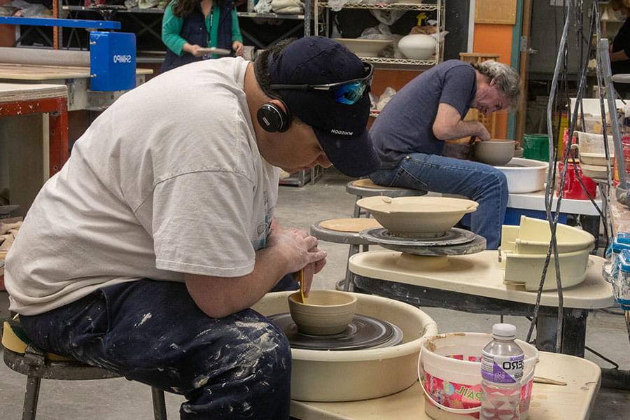 San Juan Colleges students using potter's wheel to create bowls
