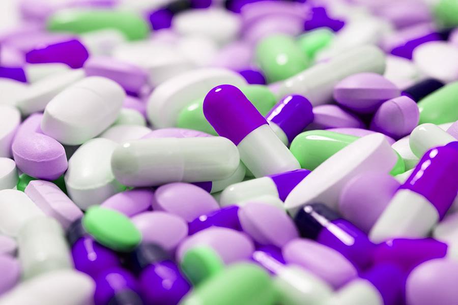 Close up image of purple, white and green colored pills