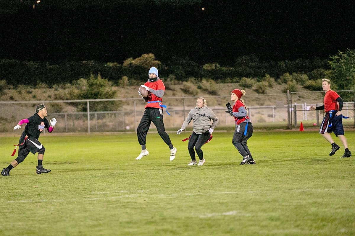 flag football game as receiver catches a pass