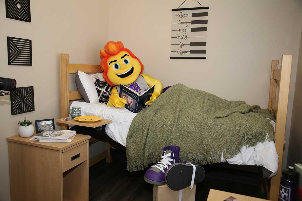 SJC Mascot, Blaze, in a dorm room.